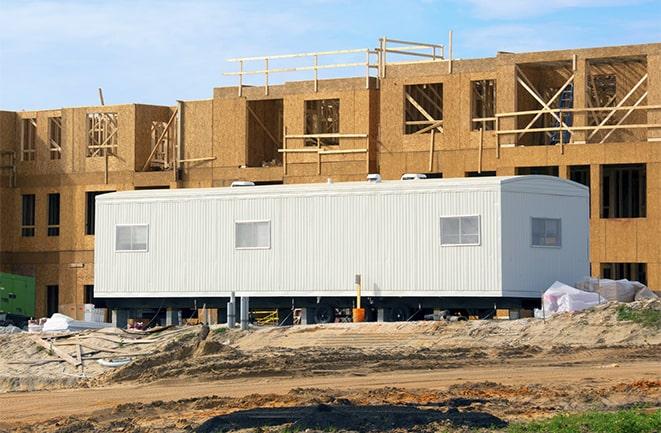 workers studying blueprints in a temporary rental office in Coral Springs